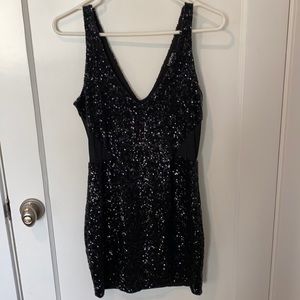 Bebe black sequin dress with mesh cut outs on the side!